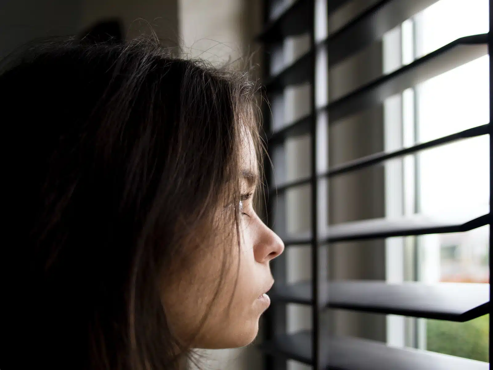 woman facing in front of window